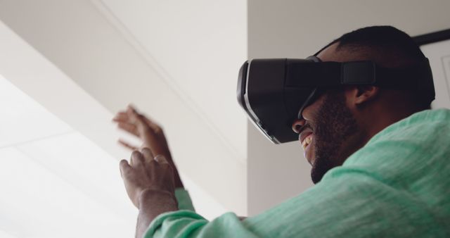 Man Wearing VR Headset Enjoying Virtual Reality Experience - Download Free Stock Images Pikwizard.com