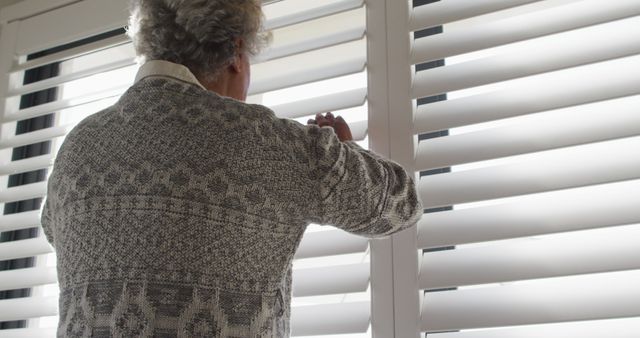 Senior Man Peeking Through Blinds in Cozy Home - Download Free Stock Images Pikwizard.com