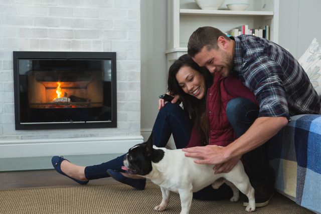 Couple relaxing with their pet dog in living room at home