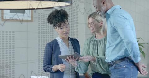 Diverse Business Team Analyzing Financial Data on Tablet