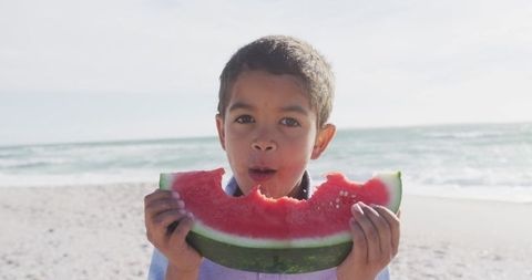 Happy Boy Enjoying Watermelon on Sunny Beach