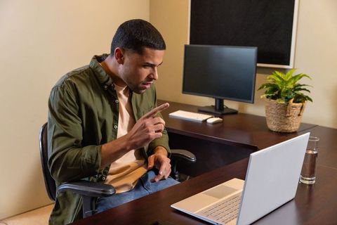 Focused professional engaging in remote work on laptop