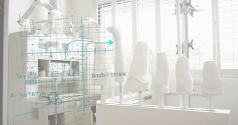 Displaying plaster dental casts on metal posts with technical overlay and measurement graphics