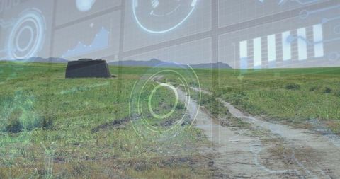 Muddy dirt track winding through grassland with hud overlay and distant bunker