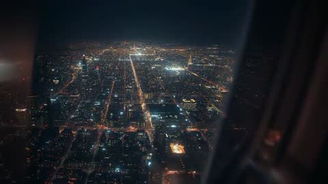 Aerial View of Modern City Grid at Night From Airplane