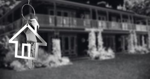 Silver House Key with Blurred Dream Home Background