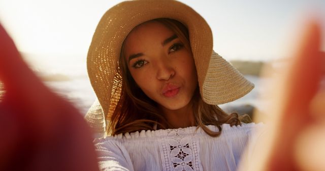 Woman Taking Selfie in Sun Hat at Beach - Download Free Stock Images Pikwizard.com