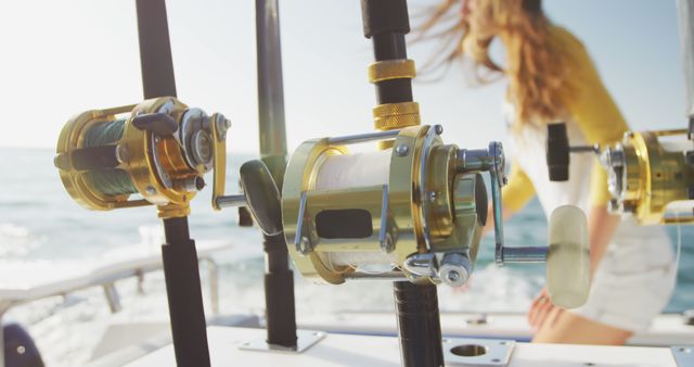 Reels of fishing rods onboard fishing boat on sunny day, with