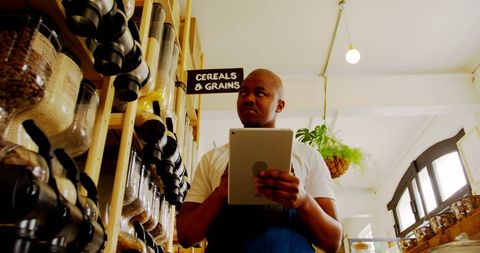 Supermarket Staff Using Digital Tablet for Inventory Management