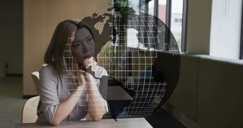 Innovative businesswoman gazing at futuristic wireframe globe