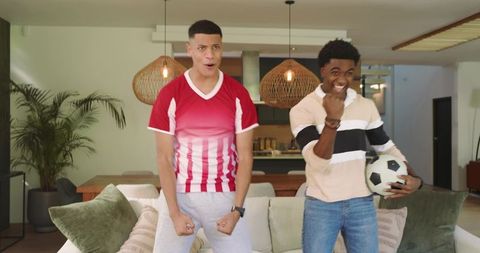 Diverse Friends in Modern Living Room with Soccer Ball and Excitement