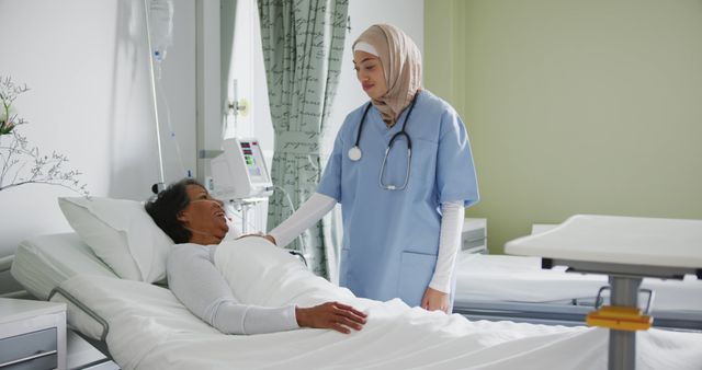 Smiling Muslim Nurse Assisting Elderly Patient in Hospital Bed - Download Free Stock Images Pikwizard.com