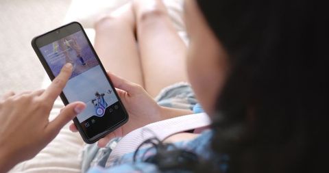 Young Woman Relaxing While Browsing Social Media on Smartphone Indoors - Download Free Stock Images Pikwizard.com
