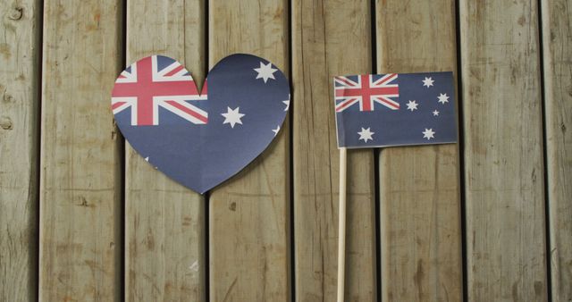 Image of flags of australia in shape of heart and rectangle on wooden background. nationality, state symbols, patriotism and independence concept.