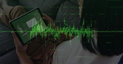 Woman analyzing data on tablet with futuristic green graphics