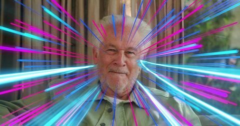 Senior man sitting in sunroom smiling with neon light streaks creating vibrant starburst