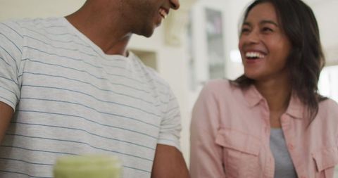 Joyful Biracial Couple Making Smoothie Together in Kitchen