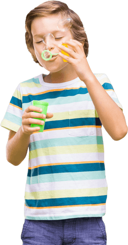 Playful boy blowing bubbles on transparent background