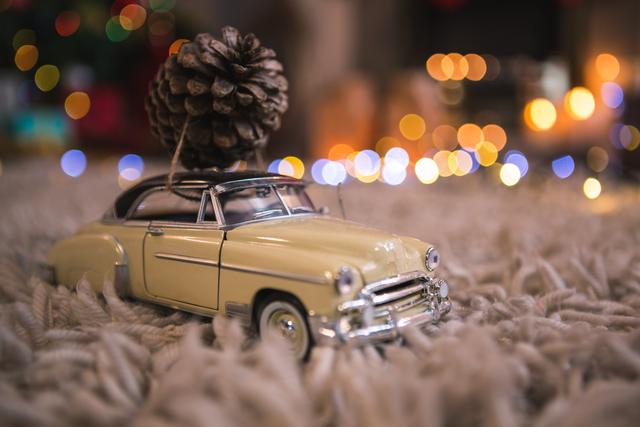 Vintage Toy Car Carrying Pine Cone on Cozy Carpet - Download Free Stock Photos Pikwizard.com