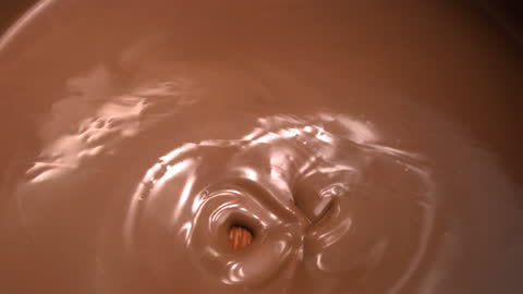 Almonds Submerging in Melted Chocolate Close-Up Slow Motion