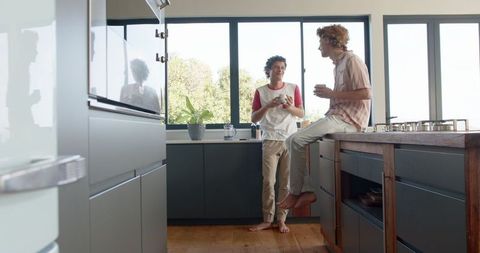 Happy Gay Couple Enjoy Twin in Modern Kitchen Setting