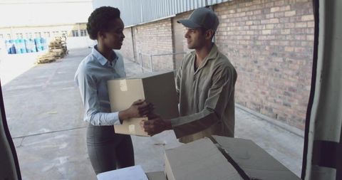 Businesswoman Receiving Package from Delivery Worker