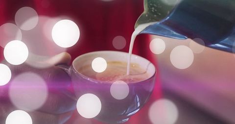 Barista crafting latte art in cozy atmosphere with bokeh lights