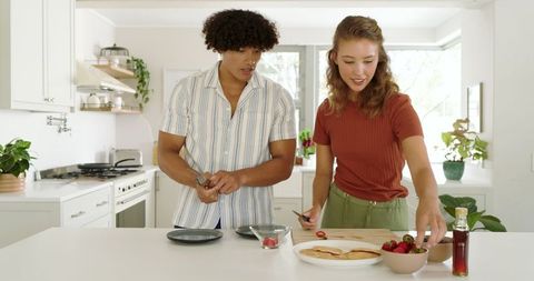 Diverse Couple Prepping Fresh Strawberries for Pancake Breakfast