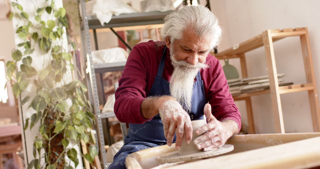 Senior Man Shaping Clay on Pottery Wheel in Workshop - Download Free Stock Images Pikwizard.com