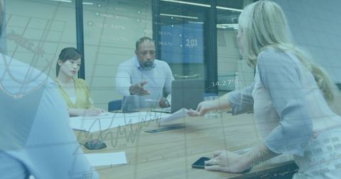 Diverse Business Team Analyzing Financial Data in Modern Meeting