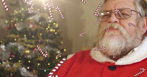 Santa claus enjoying milk with falling candy canes at christmas