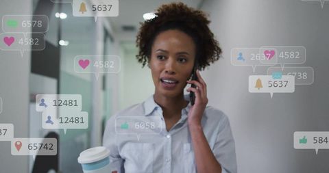 Businesswoman engaged in mobile communication with digital overlays