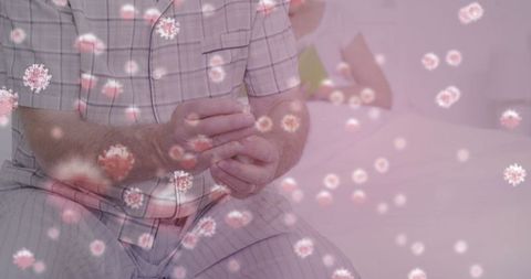 Man in pajamas feeling unwell amidst floating virus particles