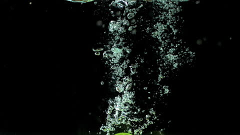 Fresh Limes Splashing Underwater