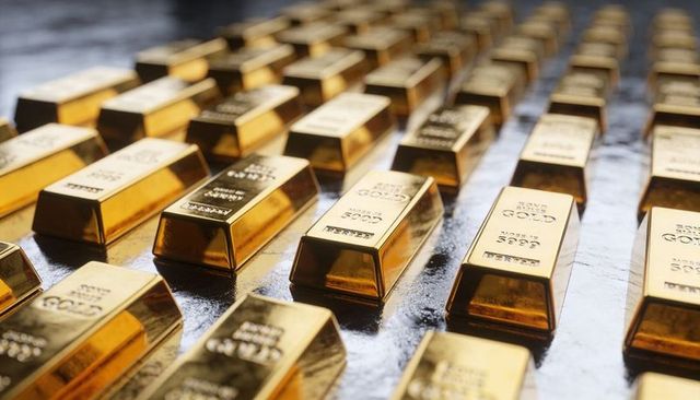 Rows of shimmering gold bars on dark vault surface reflecting luxury wealth investment