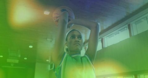 Dynamic Athlete in Action Shooting Basketball Indoors