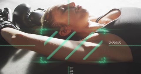 Exhausted Female Boxer Resting After Intense Workout with Futuristic HUD Overlay