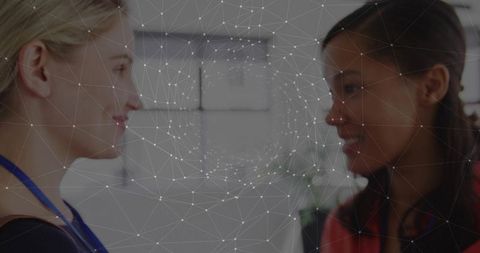 Colleagues collaborating with digital network overlay in bright office