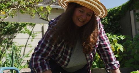 Joyful Woman Gardening in Sunlit Backyard - Download Free Stock Images Pikwizard.com