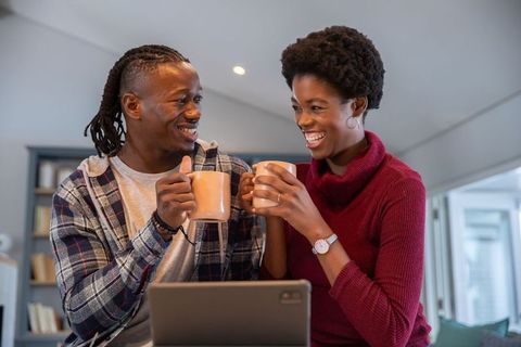 Happy African American Couple Sharing Coffee in Modern Kitchen