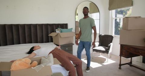 Couple moving into new home with moving boxes