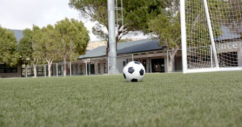 Soccer ball on artificial turf field promoting team spirit outdoors