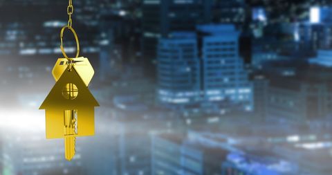 Metal House-Shaped Keychain and Urban Skyline at Night