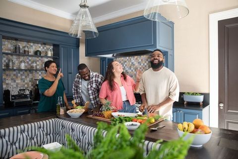 Diverse Group Enjoying Cooking Together in Modern Home Kitchen