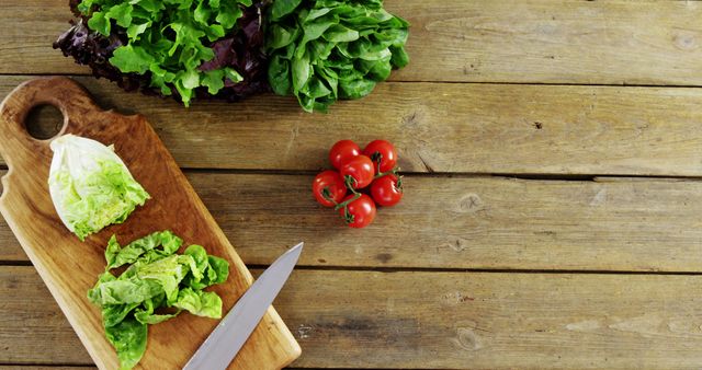 Fresh vegetables are ready to be chopped on a wooden cutting board, with copy space - Download Free Stock Photos Pikwizard.com