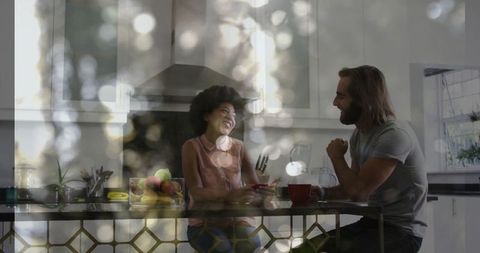 Couple bonding over coffee in modern sunlit kitchen