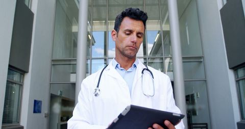 Doctor Utilizing Tablet in Hospital for Modern Healthcare Management