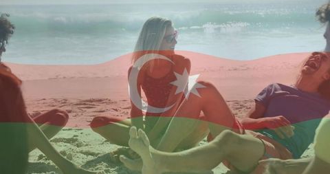 Friends relaxing and laughing on sandy beach with azerbaijani flag overlay, summer travel