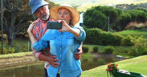 Happy Senior Couple Taking Selfie in Scenic Park