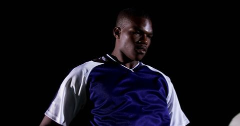 Confident Soccer Player in Sporty Action at Night